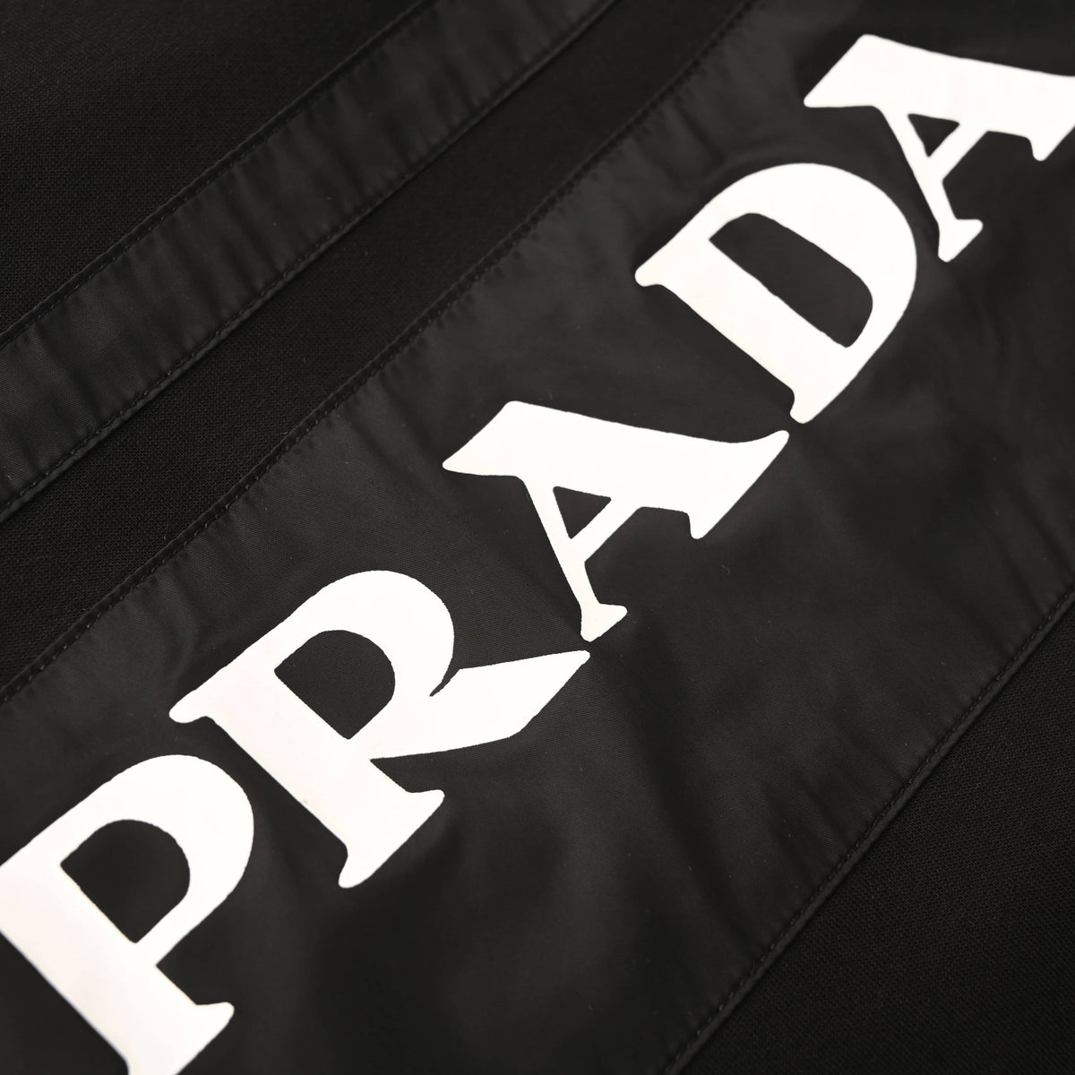 PRADA Black Logo-Panel Tapered Joggers with Red Pocket Detail